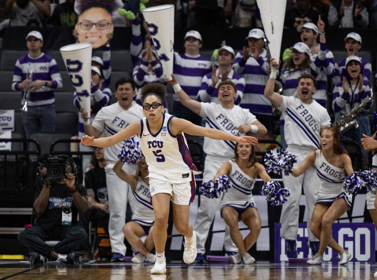Texas Christian University Horned Frogs guard Olivia Miles celebrates after making a basket as she runs up court against the Virginia Cavaliers in an NCAA Women’s Basketball Tournament Sweet 16 game Saturday at Golden 1 Center in Sacramento.