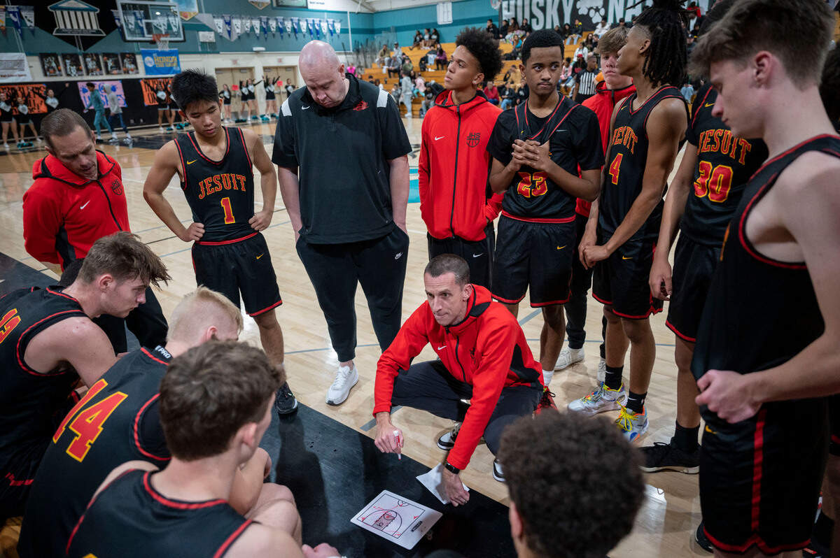 Jesuit coach Tim Kelly talks with his team during the first half of Wednesday night’s Delta League opener game against Sheldon on Wednesday night at Sheldon High School.