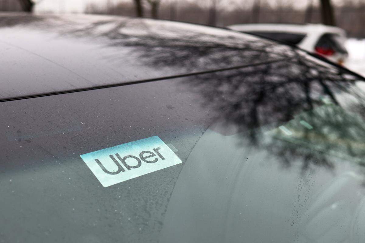 An Uber sticker is seen on a parked car in the Flatbush neighborhood of Brooklyn on February 9, 2021 in New York City. Uber has long maintained that it is a technology company that facilitates rides and is not responsible for the behavior of its drivers, who are considered independent contractors under labor law.