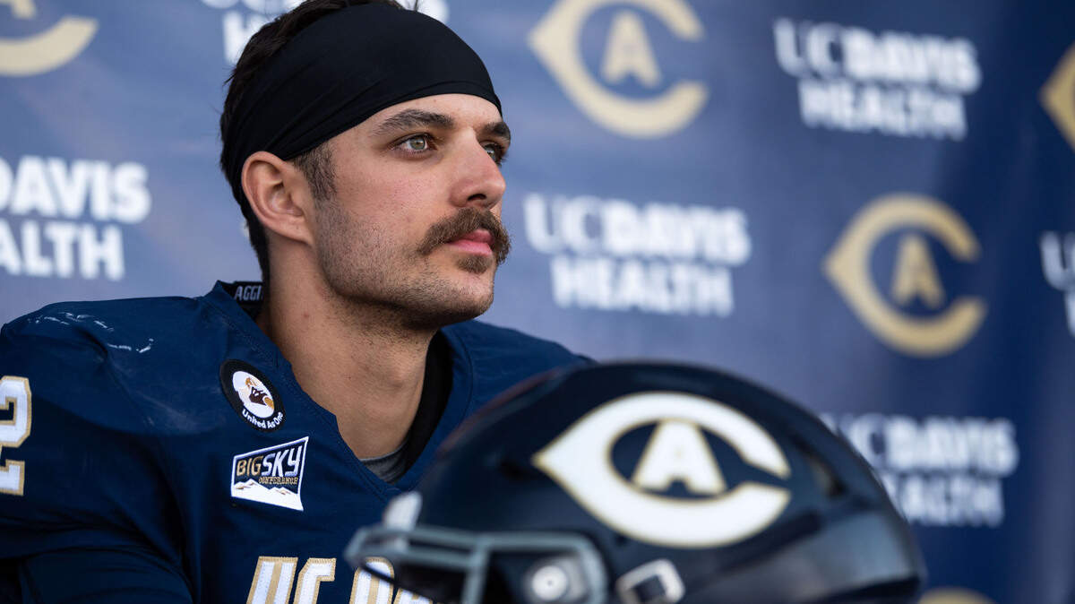 UC Davis Aggies quarterback Hunter Rodrigues (12) interviews behind his mustache after his team’s big defeat of Cal Poly during the Aggies’ first home football game of the spring season Saturday, March 20, 2021, in Davis.