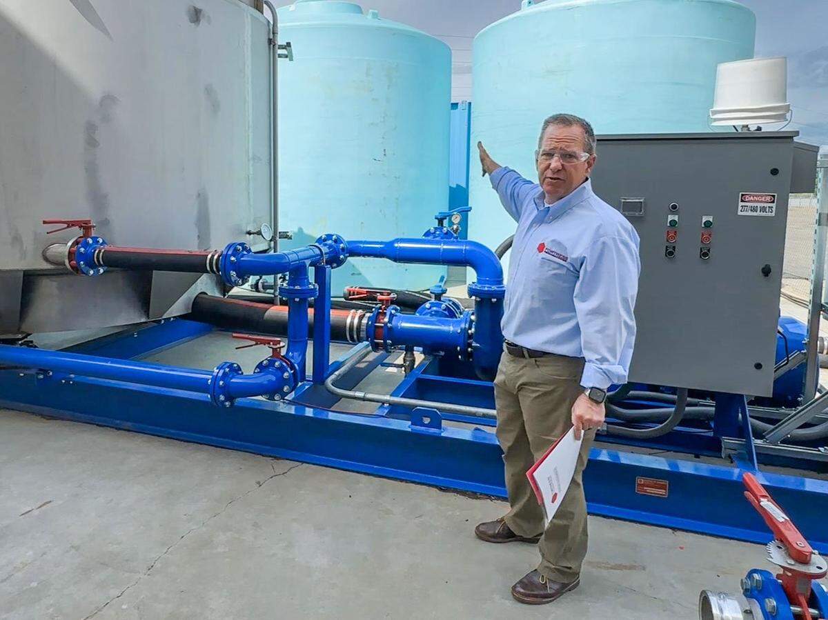 Robert Baird of Fortress Fire Retardant Systems demonstrates on May 3 some of the equipment the Rocklin company has developed to supply its fire retardant to customers. The company will start supplying Forest Service with aerial fire retardant.