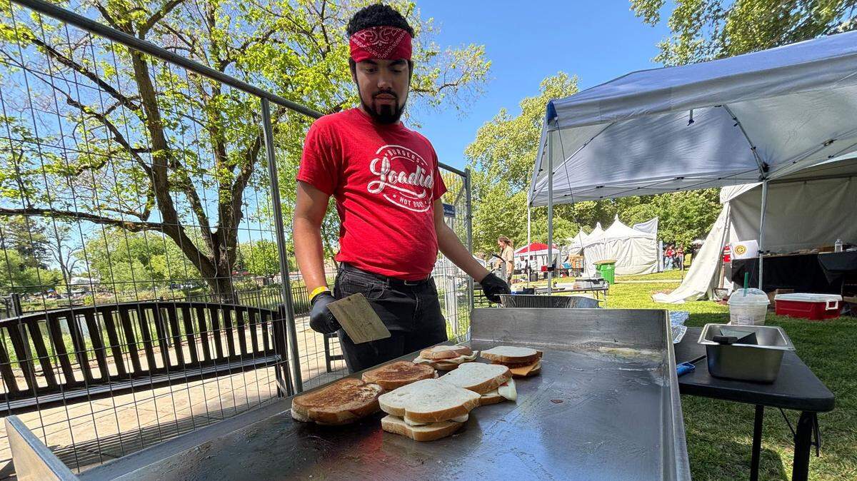 Dominick Jones of Loadid prepares grilled cheese sandwiches for the Sacramento Grilled Cheese Festival at Southside Park on Saturday. The festival continues Sunday.