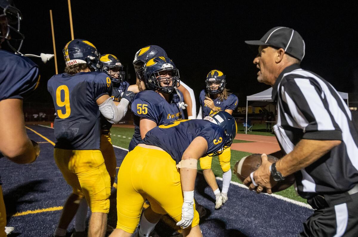 Oak Ridge players celebrate one of multiple touchdowns against Vacaville, many off passes thrown by quarterback Maddox Varella (4), rear at right, during the second quarter of the high school varsity football game Friday at Oak Ridge High School in El Dorado Hills.