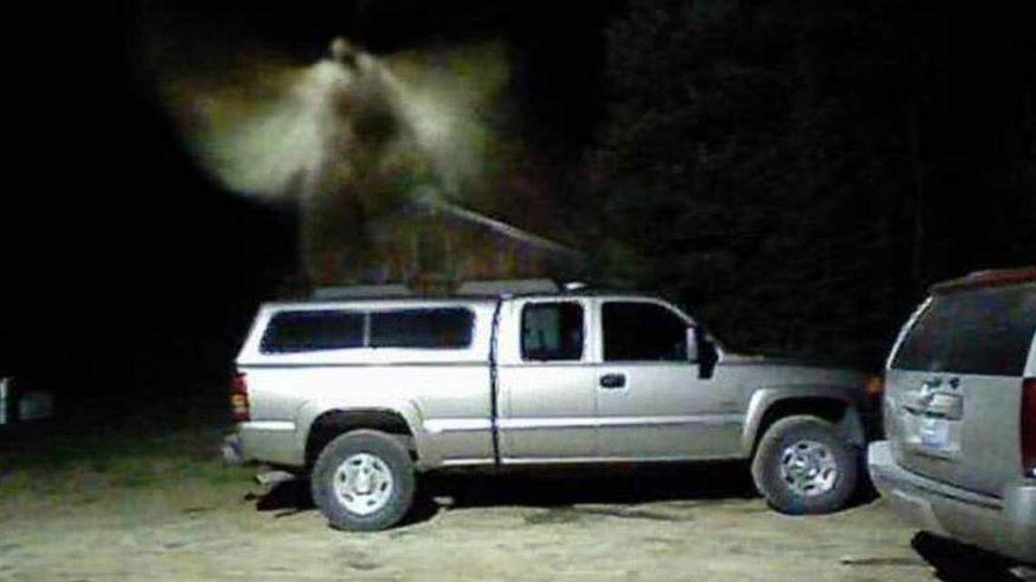 A security camera photo of a blurry image seeming to hover above a parked pickup truck in East Jordan, Mich., has sparked a vigorous online debate over whether it depicts an angel or a moth. Jordan Rivers Church posted the photo to Facebook on Wednesday.