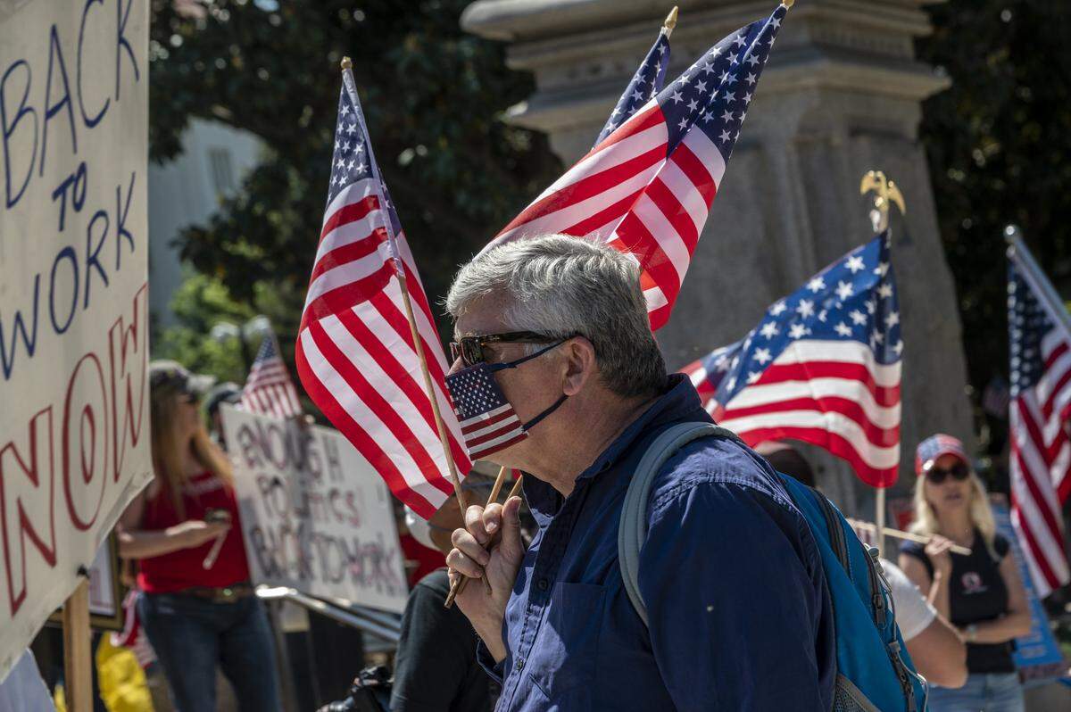 Protesters demonstrate at the Capitol in Sacramento on Friday, May 1, 2020, against Gov. Gavin Newsoms stay-at-home order to slow the spread of the coronavirus.