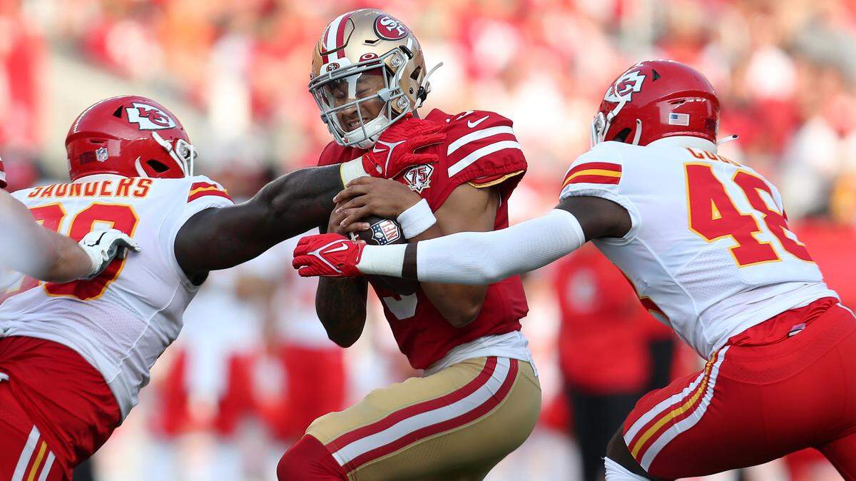 Kansas City’s Omari Cobb, right, reaches for San Francisco quarterback Trey Lance as defensive tackle Khalen Saunders approaches on Saturday, Aug. 14, 2021.