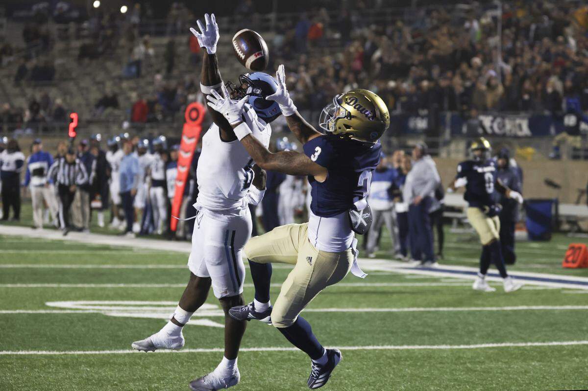 UC Davis Aggies wide receiver Zach Jones (3) catches the ball as Rhode Island Rams defensive back Ayinde Johnson (6) defends for a 35-yard touchdown in the fourth quarter of a second-round NCAA Division FCS playoff game at UC Davis Health Stadium on Saturday.