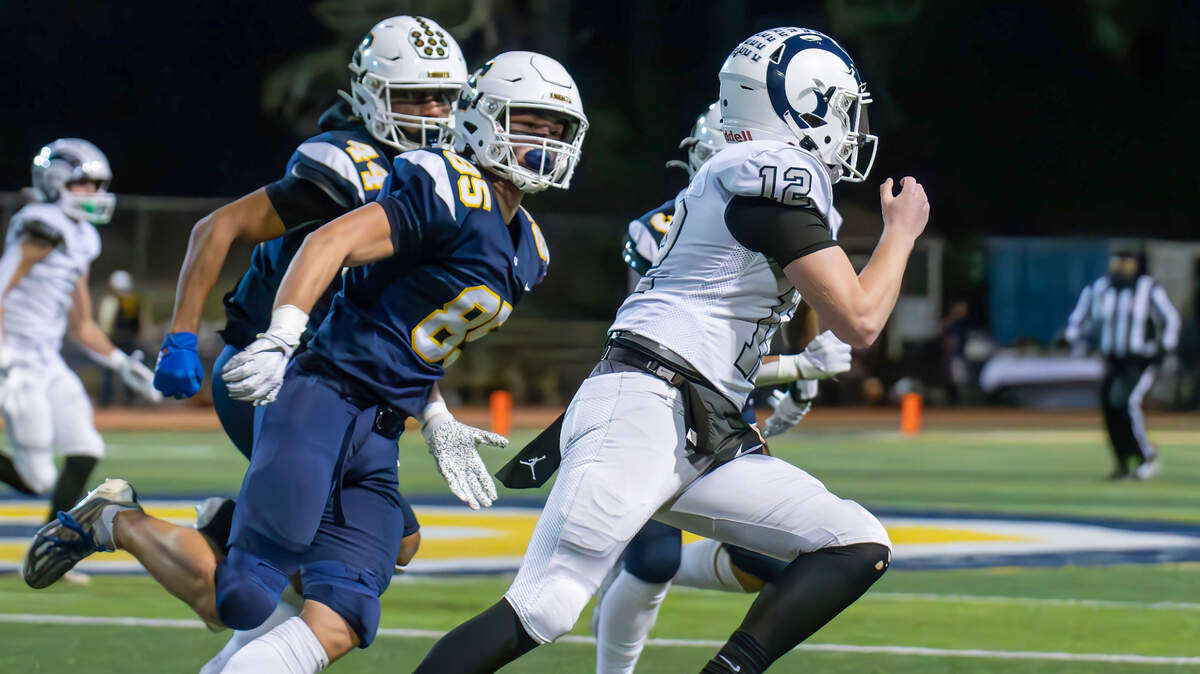 Casa Roble quarterback Connor Campbell runs for a short gain against Soquel defenders in the CIF Northern California Division 4-AA championship game in Soquel on Friday.