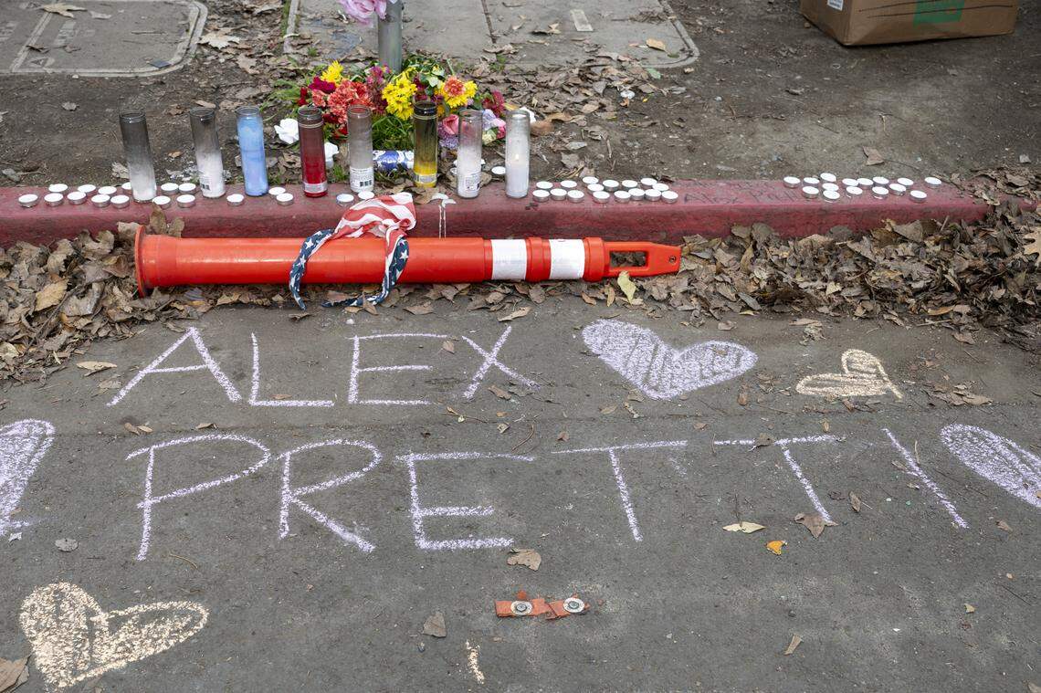 A memorial for Alex Pretti, who was killed in Minneapolis on Jan. 24, is decorated with candles and flowers during a protest outside the John Moss Federal Building in Sacramento on Sunday.