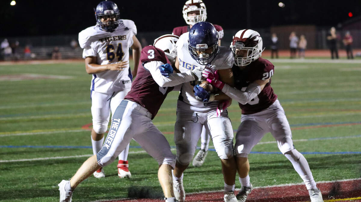 Inderkum’s Dexter Simmons pushes through two Woodcreek defenders for a touchdown Friday.