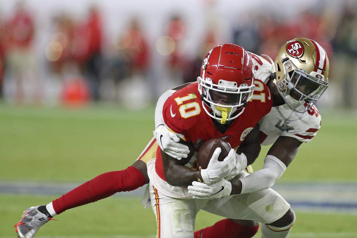 Kansas City wide receiver Tyreek Hill is tackled after a catch by Emmanuel Moseley.