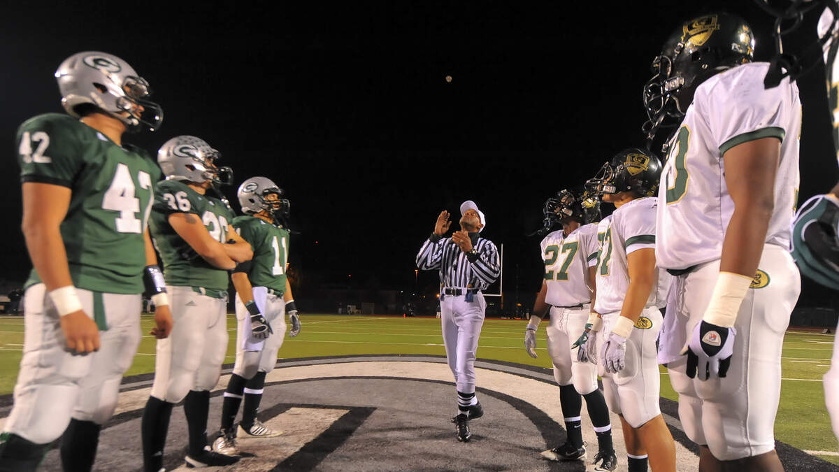 The referee tosses the coin at the start of the game as Granite Bay High School hosts Monterey Trail for the Division I semifinal football game Friday Nov. 26, 2010. Monterey Trail won the game 22-17. Photo Brian Baer