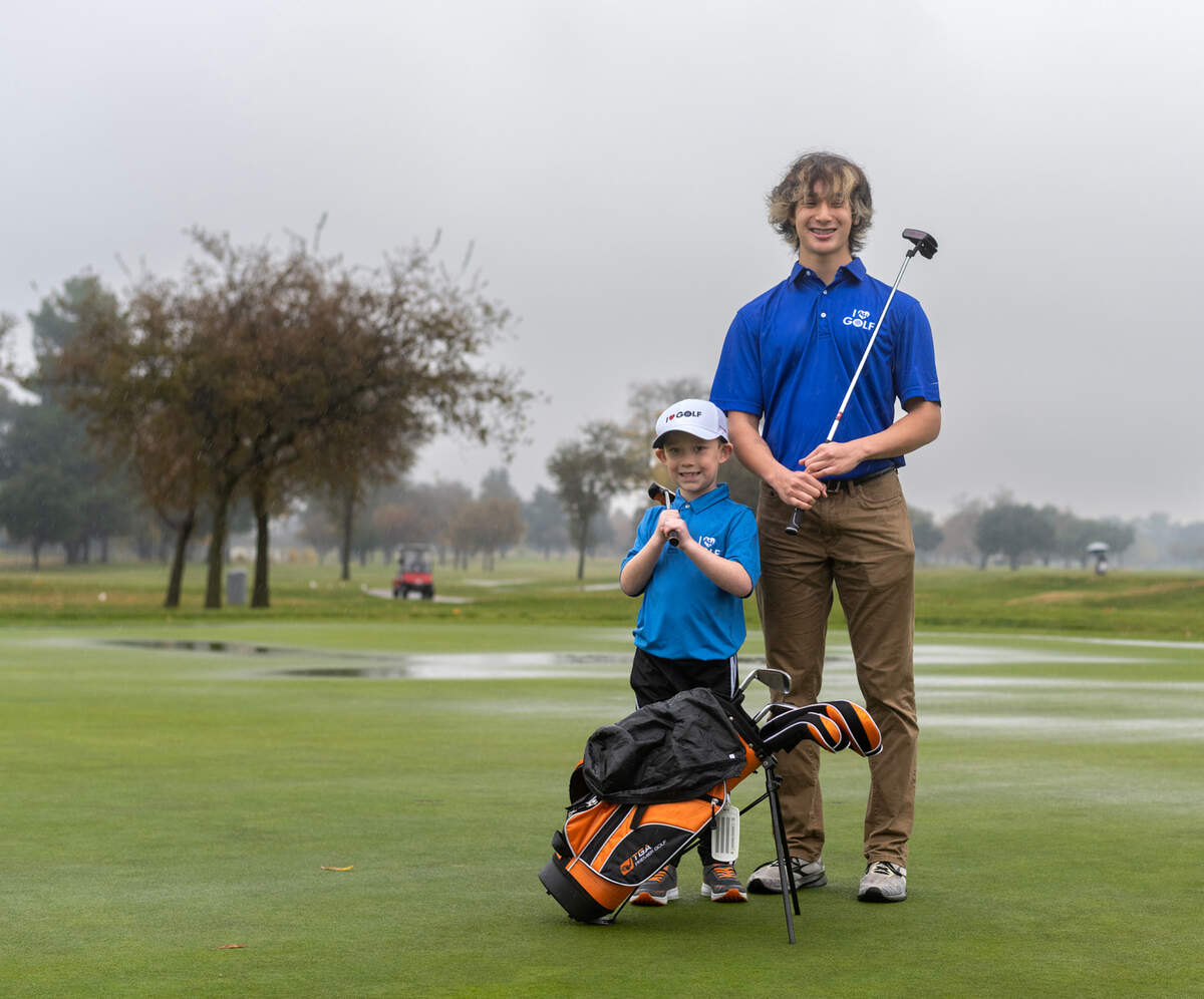 Joseph Castillo, right, and Jackson Reichert stand on the green at Haggin Oaks Golf Course on Saturday, Dec. 3. They are both involved in the Angels for Hearts golf program as golf is one of the few sports they can play with their heart conditions.