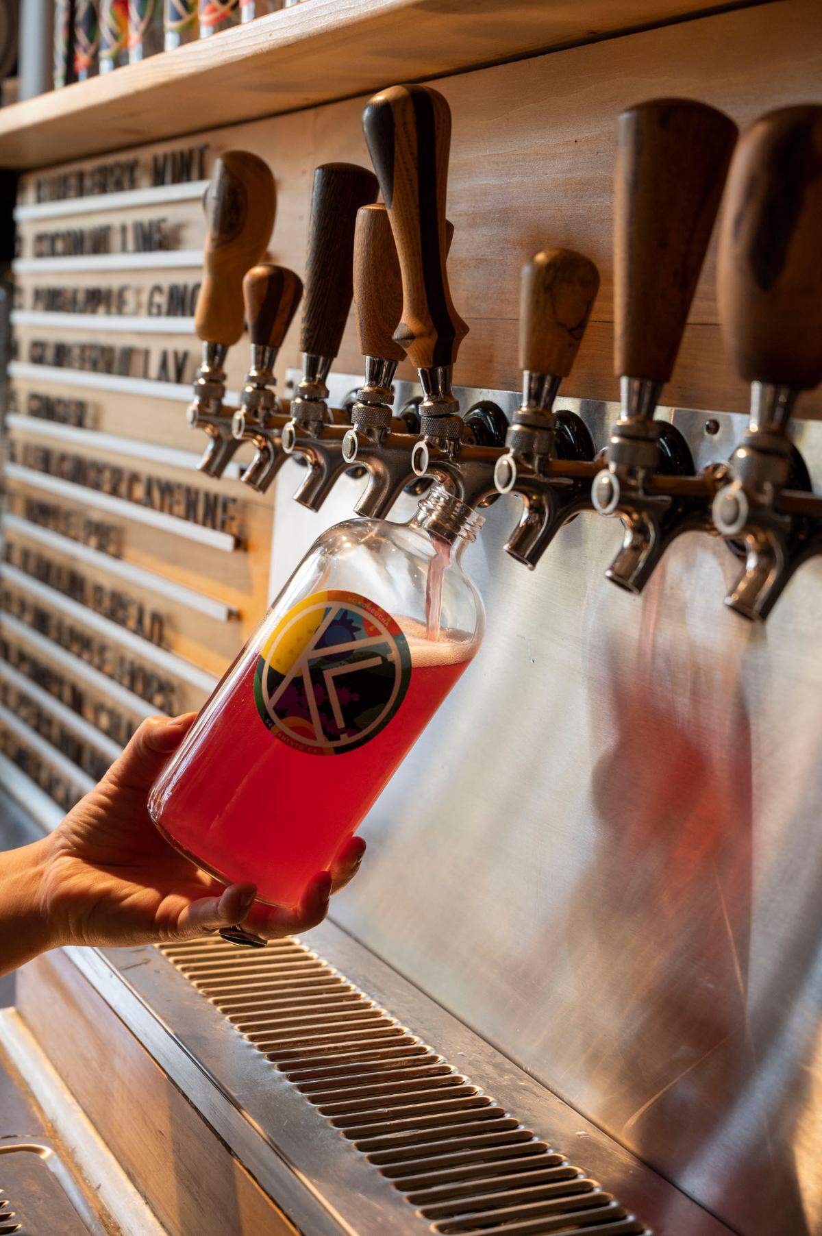 KC Kombucha’s top seller, blueberry mint, is poured into a refillable bottle, Nov. 5, 2021, in North Oak Park. The company announced it would be closing its taproom next month.