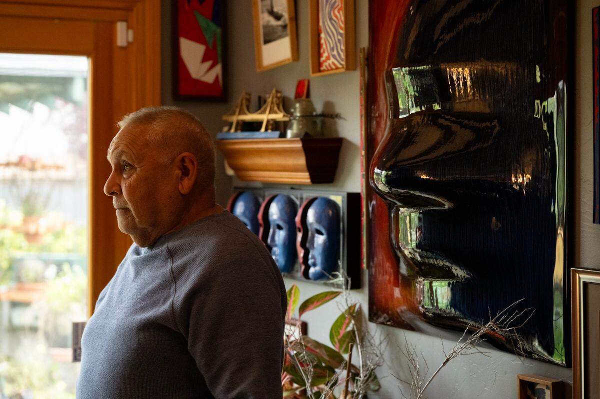 Carlos Olivas Jr. poses next to a sculpture he created of his profile at his home in Sacramento earlier this month.