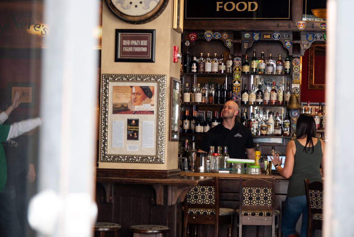 DeVeres Irish Pub on L Street works to serve takeout food outside on St. Patricks Day, March 17, 2020, on as restaurants and bars react to the coronavirus in Sacramento. DeVeres was closing operations at 6 p.m. in response to social distancing measures.