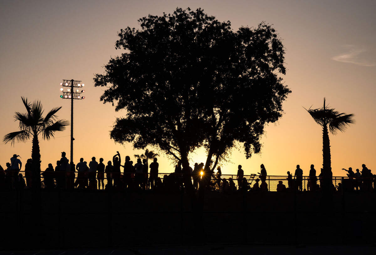The sun falls past friends and family attending Grant Union High School’s graduation ceremony Thursday, June 1, 2023, in Sacramento’s Del Paso Heights neighborhood.