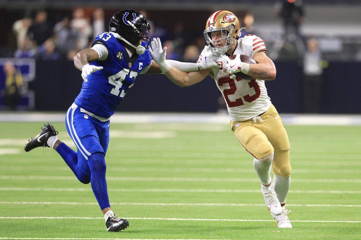 INDIANAPOLIS, INDIANA - DECEMBER 22: Christian McCaffrey #23 of the San Francisco 49ers stiff arms Cameron Mitchell #43 of the Indianapolis Colts during the fourth quarter of the game at Lucas Oil Stadium on December 22, 2025 in Indianapolis, Indiana. (Photo by Justin Casterline/Getty Images)