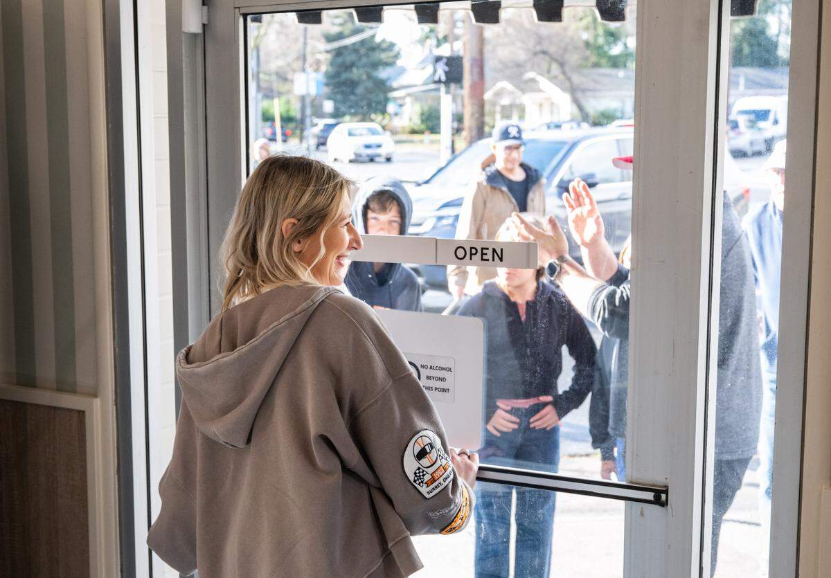 Owner Samantha Grifone officially unlocks the door to Vic’s Ice Cream in Sacramento for its reopening on Saturday.