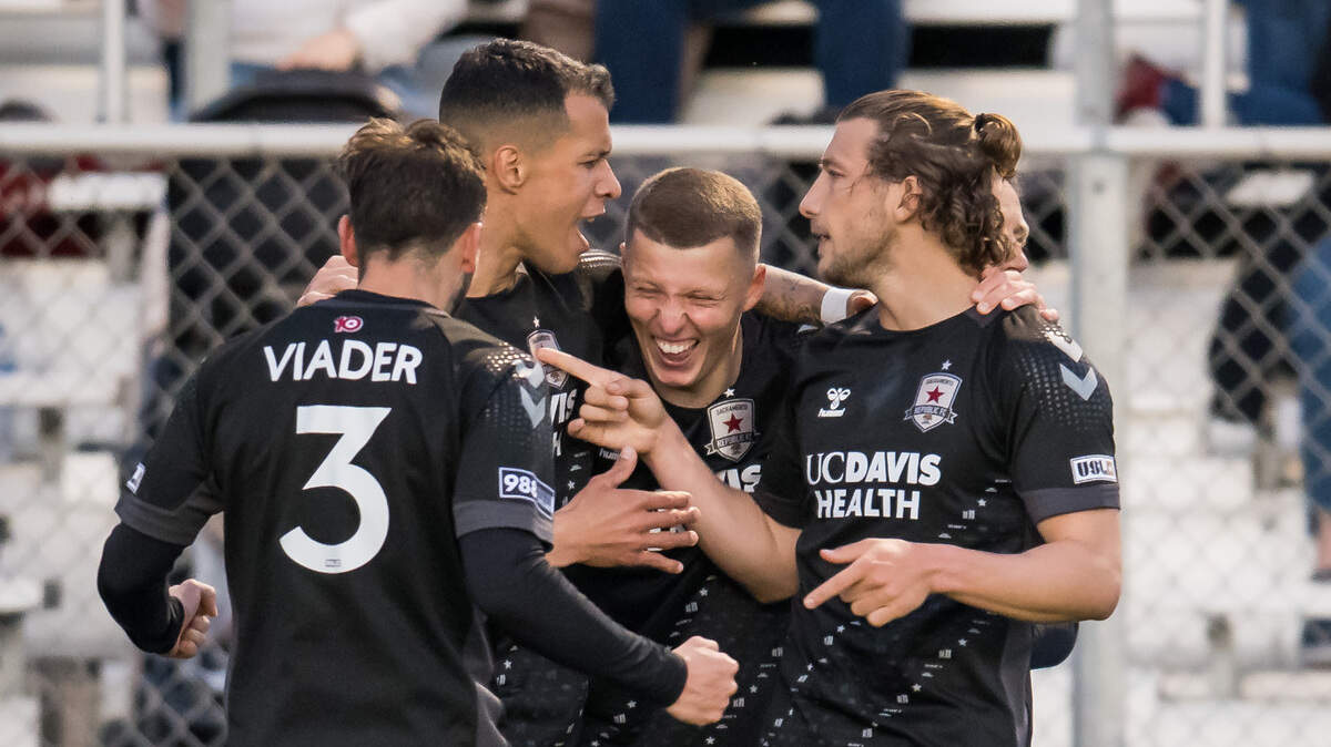 Sacramento Republic FC forward Russell Cicerone (11), right, and midfielder Luis Felipe (96) surround laughing defender Jack Gurr (2) after his goal during the first half against Louisville City FC at the USL soccer game Saturday, April 1, 2023, at Heart Health Park. Sac Republic shut out Louisville 5-0.
