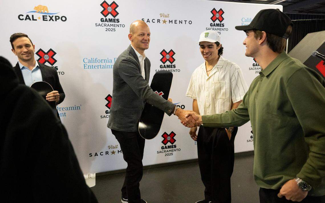 Sacramento Mayor Kevin McCarty shakes hands with Lodi native Bryce Tyron, a BMX dirt and X Games silver medalist, as BMX athlete Kevin Peraza stands nearby after the announcement on Thursday that the X Games will be held at Cal Expo in Sacramento for at least three years starting in 2025.