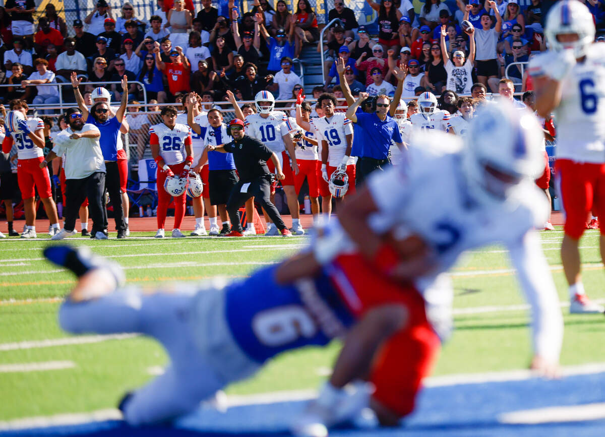 The Folsom sideline cheers as Ryder Lyons (3) scores a touchdown against Serra's Justin Miller (6) in the fourth quarter at Serra High School in San Mateo on Saturday.