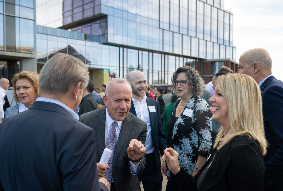 Sacramento Mayor Darrell Steinberg jokes with Dennis Mangers, a former political advisor to Steinberg, left, and the Sacramento Region Community Foundation’s Kerry Wood, right, before his final State of the City address on Thursday at Aggie Square. Behind Steinberg stand his son Ari and wife Julie.