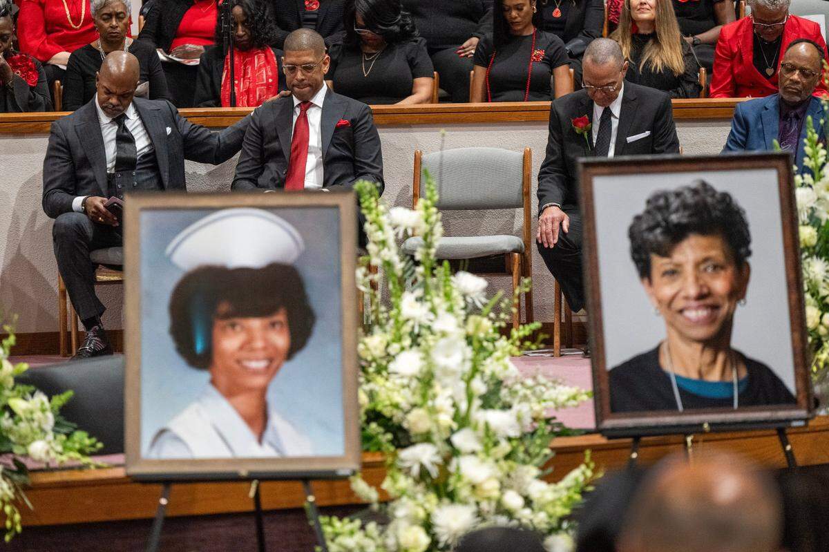 Former Sacramento mayor Kevin Johnson, second from left, has a moment of prayer at the celebration of life memorial service for his mother Georgia West, the driving force behind Underground Books in Oak Park, at Saint Paul Church in Sacramento on Thursday, Jan. 23, 2024.