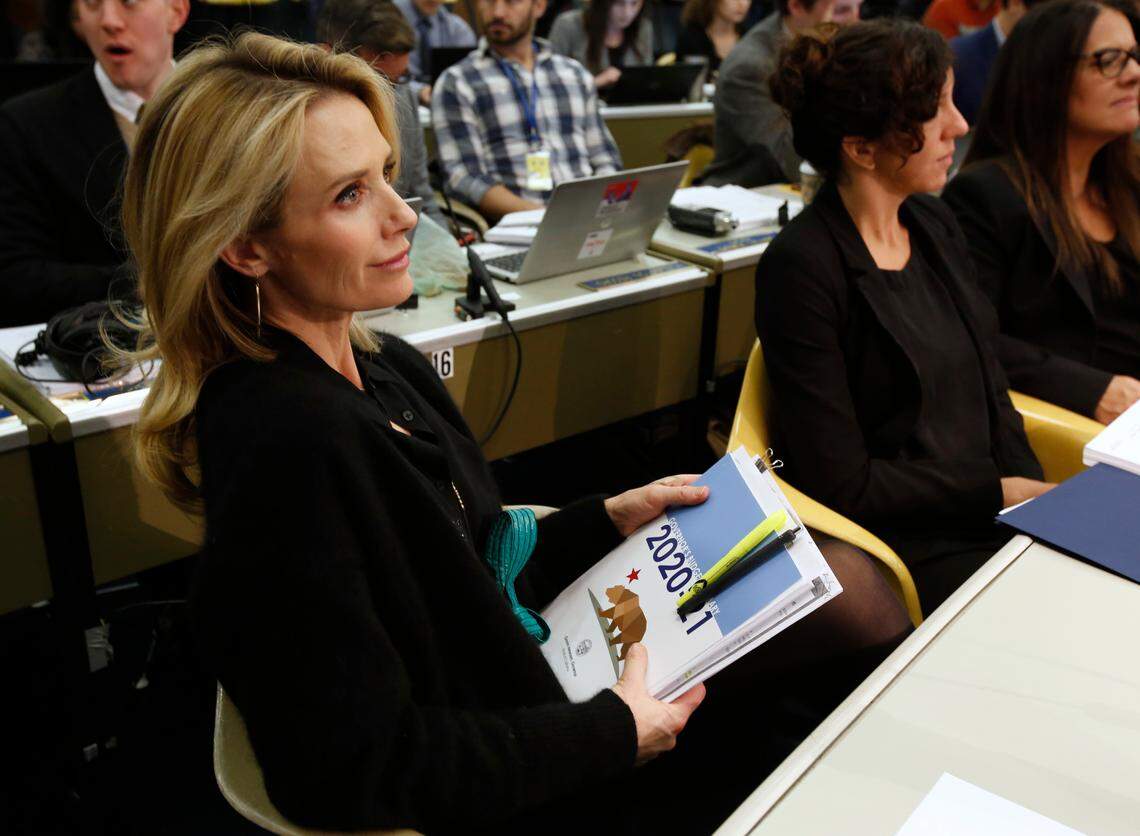 California First Partner Jennifer Siebel Newsom listens as her husband, California Gov. Gavin Newsom, discusses his proposed 2020-2021 state budget during a news conference in Sacramento on Jan. 10, 2020.