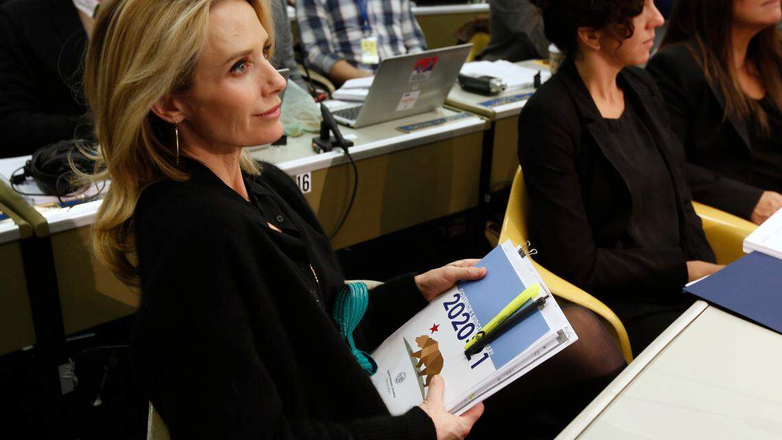 California First Partner Jennifer Siebel Newsom listens as her husband, California Gov. Gavin Newsom, discusses his proposed 2020-2021 state budget during a news conference in Sacramento on Jan. 10, 2020.