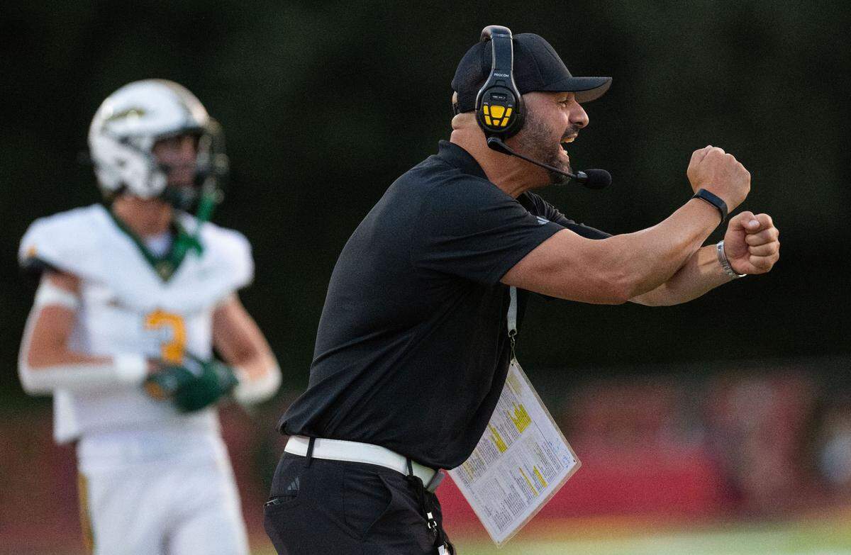 Rio Americano coach Bob Ghazanfari sends in a play against Jesuit on Friday at Jesuit High School in Carmichael.