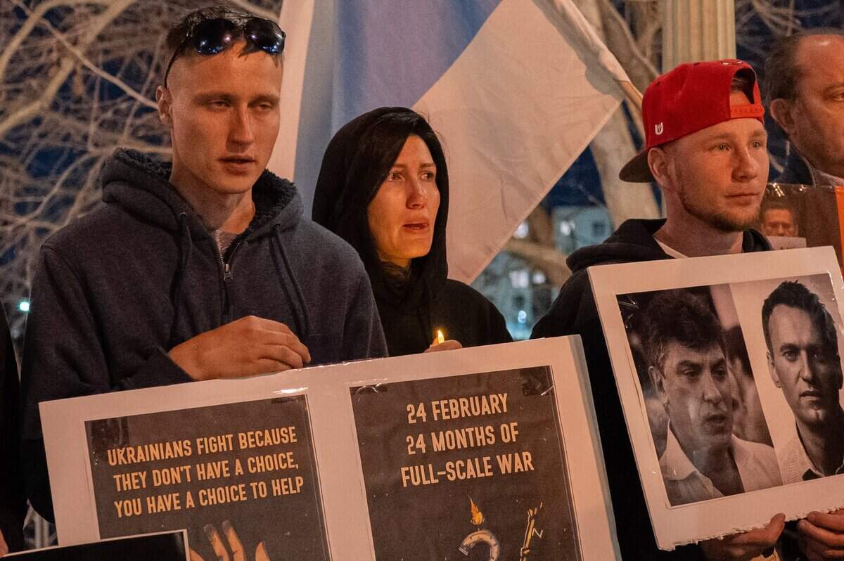 Demonstrators hold signs marking the second anniversary of Russia’s invasion of Ukraine during a candlelight vigil near the Tower Bridge in Sacramento on to mourn the loss of Alexei Navalny, the Russian opposition leader who died in an Arctic penal colony earlier this month.