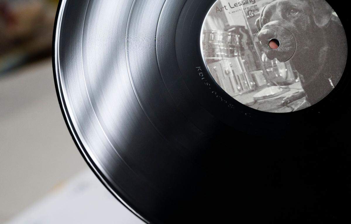 An album produced by KDVS Recordings is shown by a DJ at the studio. The record label, founded by the student-run community radio station KDVS, promotes independent artists in the Sacramento and Davis areas.