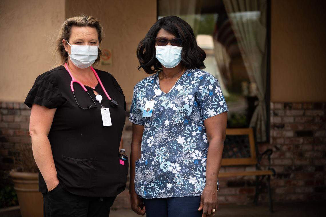 Dawn&nbsp;Calkins, left, former City Creek Post Acute director of nursing, and Lina Young, housekeeping supervisor, stand outside the facility formerly known as Saint Claire’s Nursing Center on May 14, 2020, in south Sacramento. The new ownership is trying to reinvent the skilled nursing facility amid the COVID-19 pandemic. Calkins said since the coronavirus started appearing in other congregant care facilities, internal efforts to make changes to allow for more high-acuity patients have been slowed. “But we’re hopeful, we really believe this is going to just be an amazing building, and we really take pride in what we do,” she said in May.