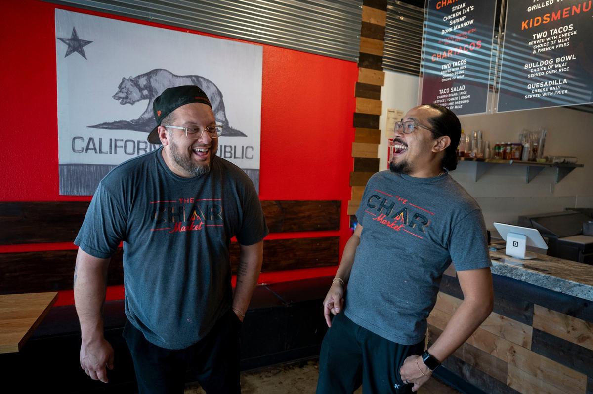 Co-owners Shane Cichy, left, and Noah Corsey joke around while talking at Char Market in Carmichael on Thursday.