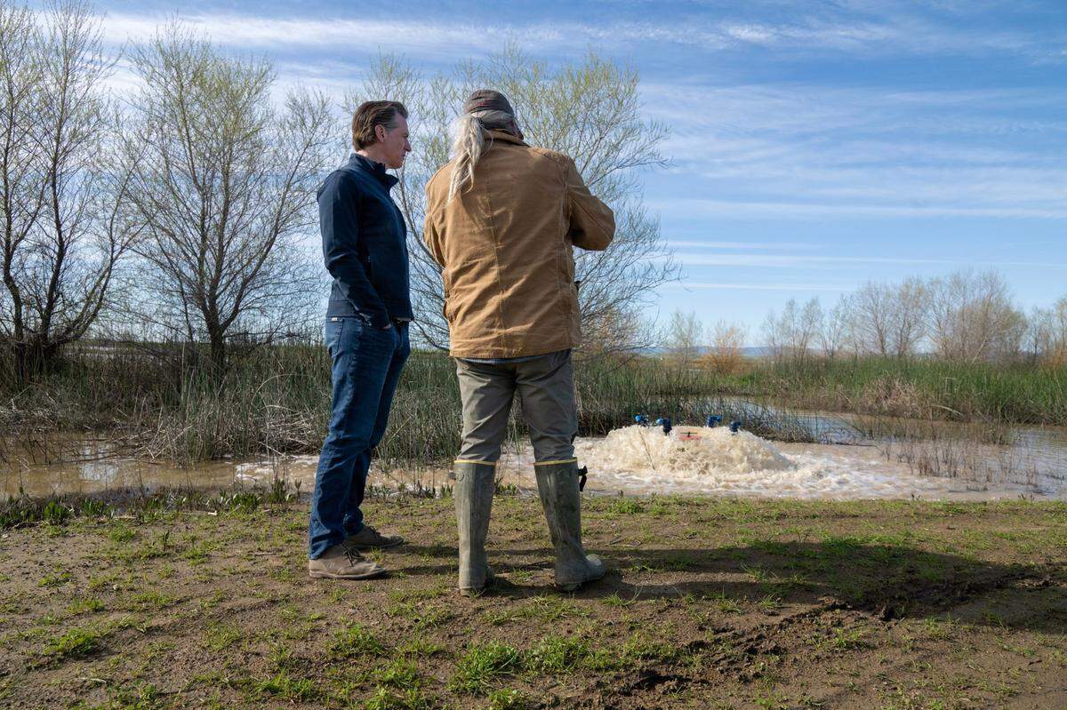 Gov. Gavin Newsom tours Brian and Elena Corral’s 810 acres of Dunnigan farmland on Friday, March 24, 2023, to observe how recycled collected water is being used to flood the property to recharge Yolo County’s groundwater aquifer. Newsom announced an end to some of the state’s water restrictions.