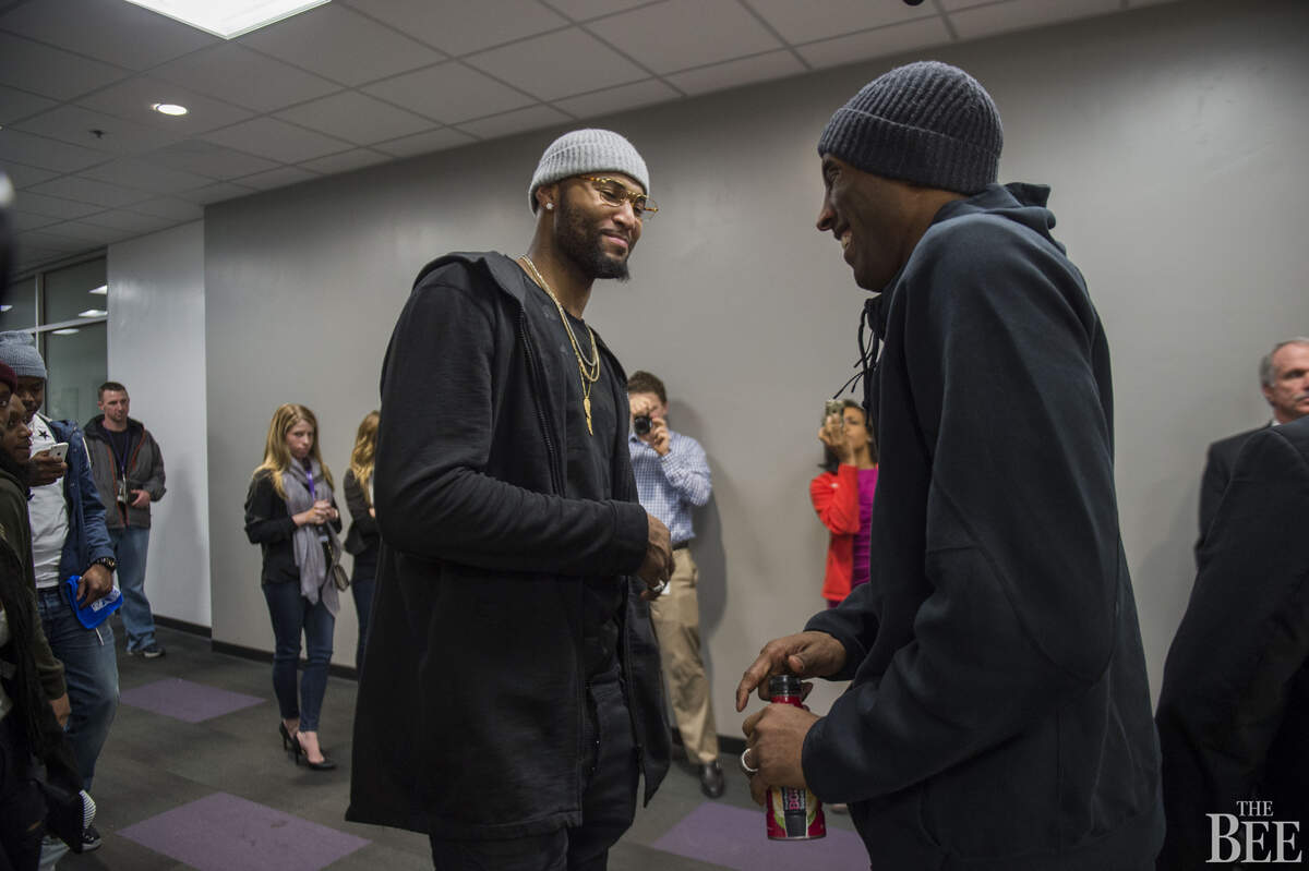 Sacramento Kings forward DeMarcus Cousins (15) shares moment with Los Angeles Lakers forward Kobe Bryant (24) after he held a press conference to talk about his last game as a Laker in Sacramento.