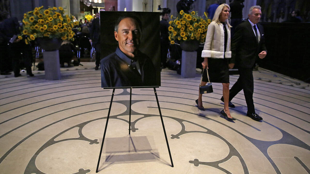 Hall of Fame quarterback Joe Montana walks with wife Jennifer after attending a memorial service for former 49ers teammate Dwight Clark at Grace Cathedral on Wednesday in San Francisco. Clark, who died of ALS on June 4, is known for making “The Catch” from Montana that sent the 49ers to Super Bowl XVI in 1982.