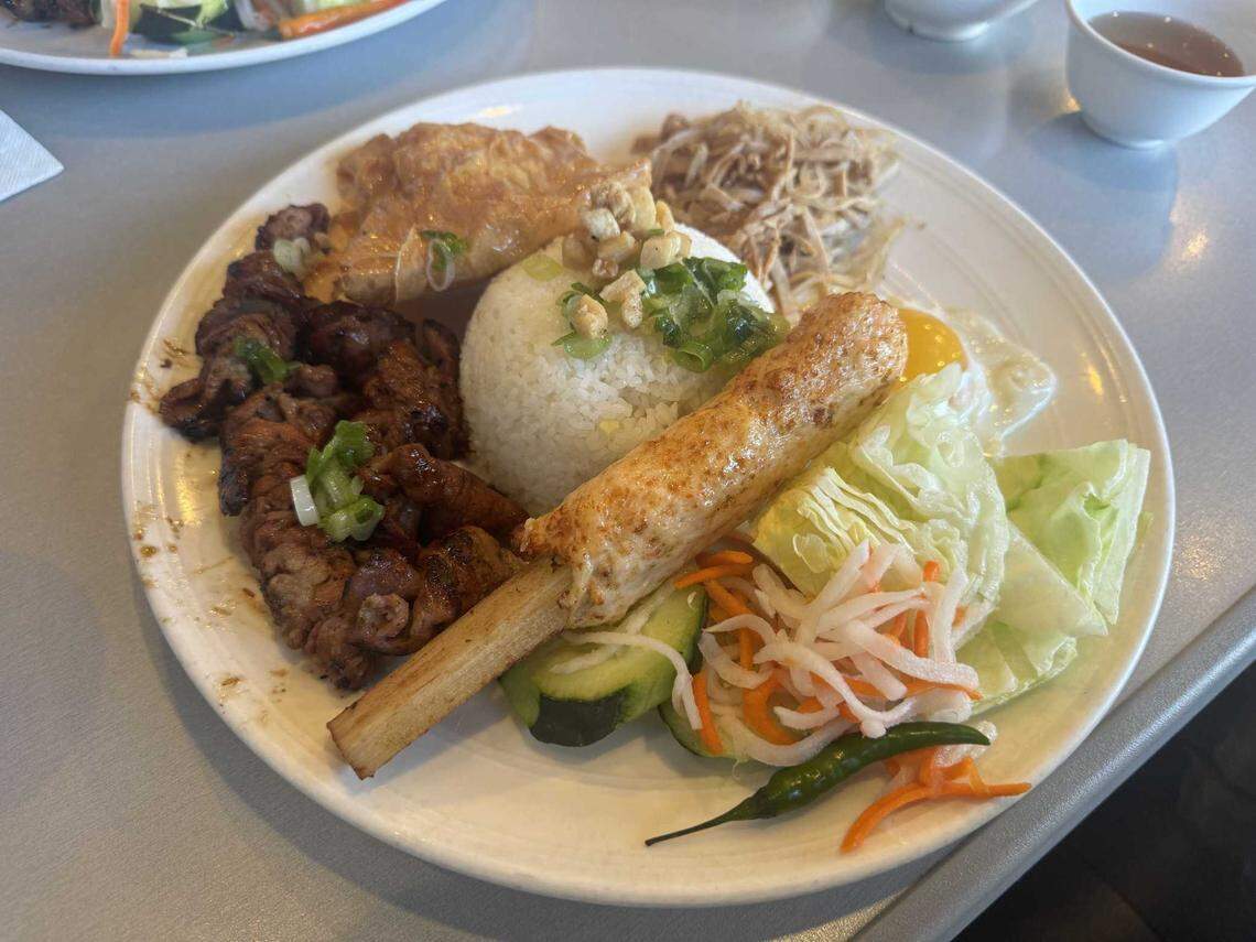 Com Tam Thien Huong’s No. 70 plate includes rice, barbecue pork, shredded pork skin, a fried egg, and grilled shrimp on a sugarcane stick.