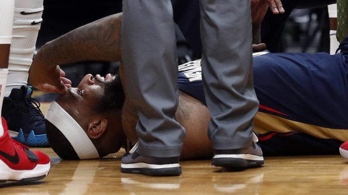 In this Jan. 26, 2018, file photo, then-New Orleans Pelicans center DeMarcus Cousins lies on the court while being tended to after an injury. Cousins is undergoing tests to confirm a preliminary diagnosis of a ligament tear in his knee in a more recent injury.