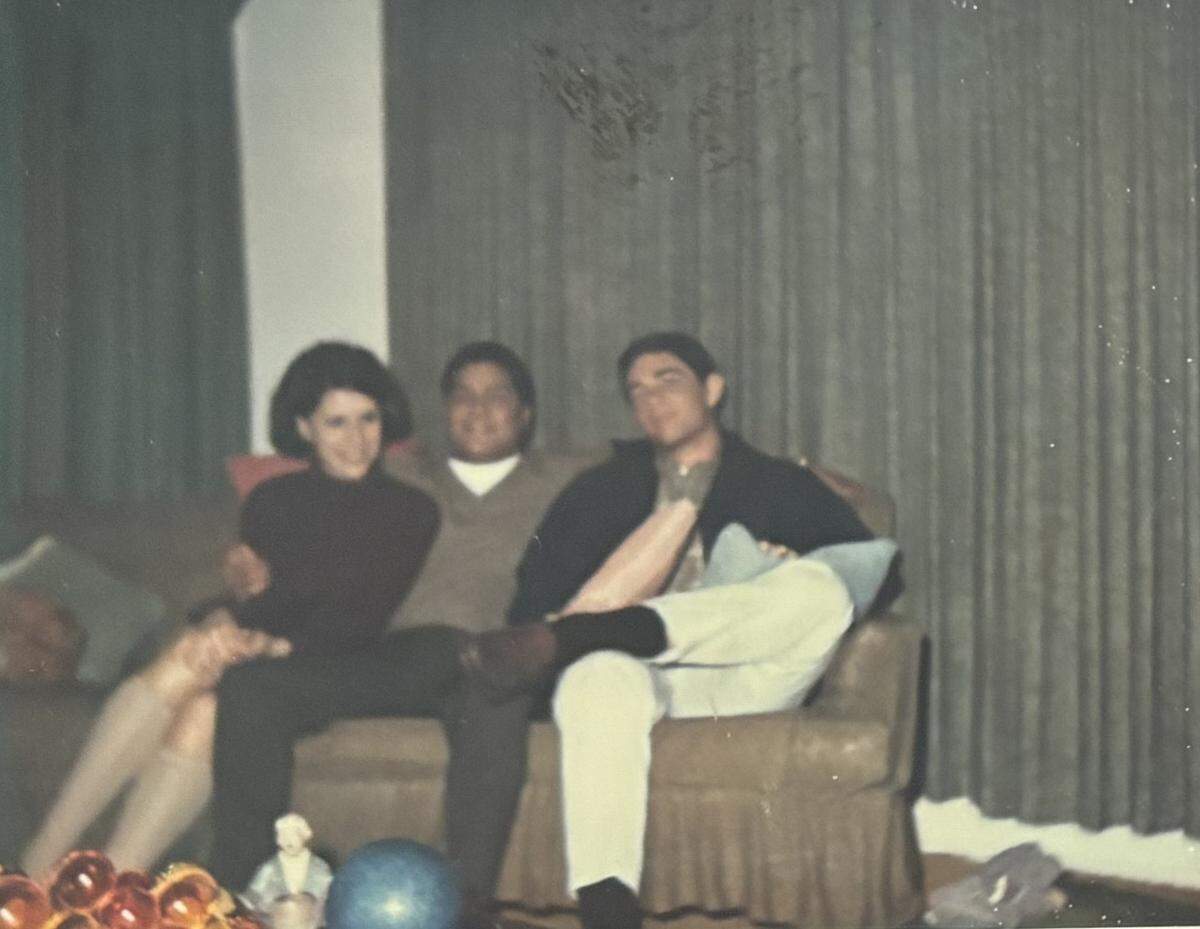 Manuel Gines, center and his friend Art Ybarra, at right, sit with an unidentified woman. Gines was killed in an accident in 1968 while serving in the Vietnam War.