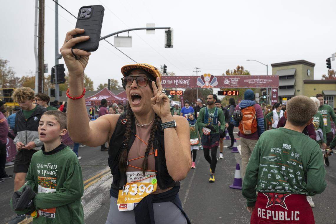Runners cross the finish line of the 10k race during the Run to Feed the Hungry in Sacramento on Thursday.