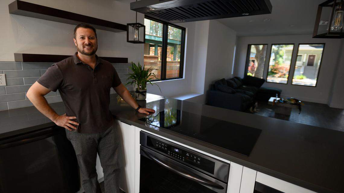 California developer Joaquin Rangel shows an induction cook top stove at his new Zero Net Energy buildings that use Telsa batteries on Oct. 25, 2019.