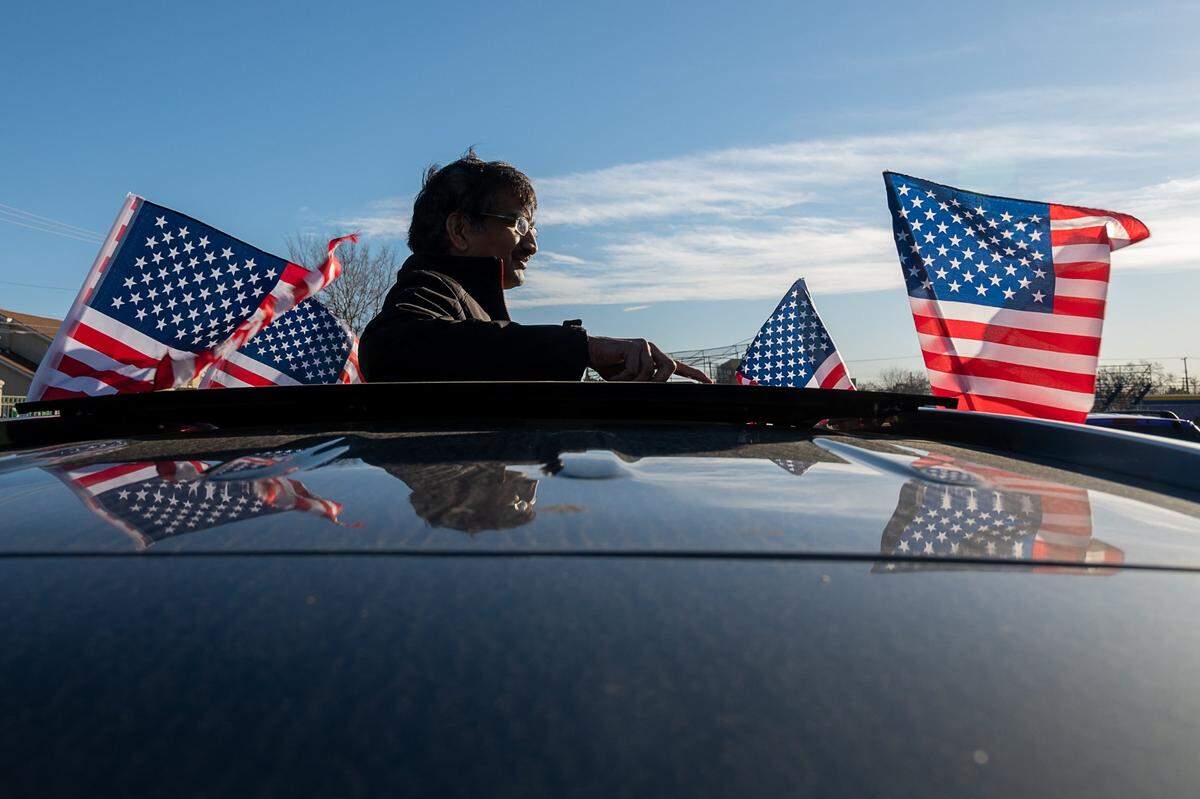 Bhaskkar Vempati looks out of the sunroof of his car at the start of a #ReclaimMLK Day car caravan in celebration of Martin Luther King Jr. Day at Grant High School in Sacramento on Monday, Jan. 18, 2021.