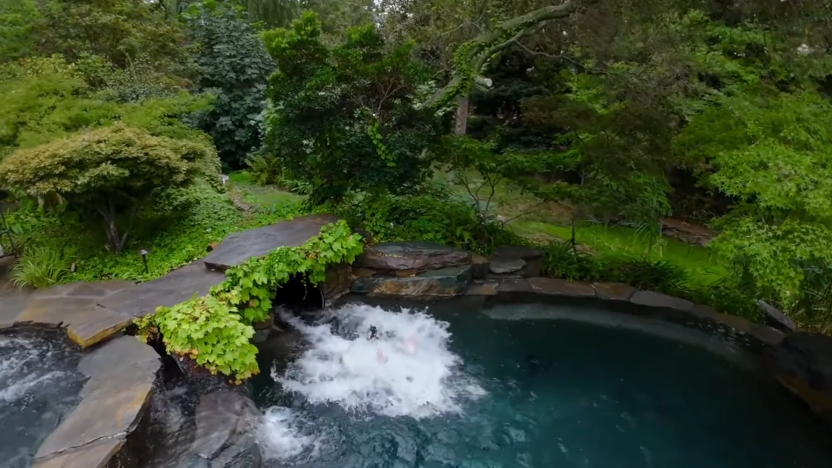 A 145-foot custom waterslide thrills guests, ending in the estate’s sparkling Pebble Tec lagoon-style pool.