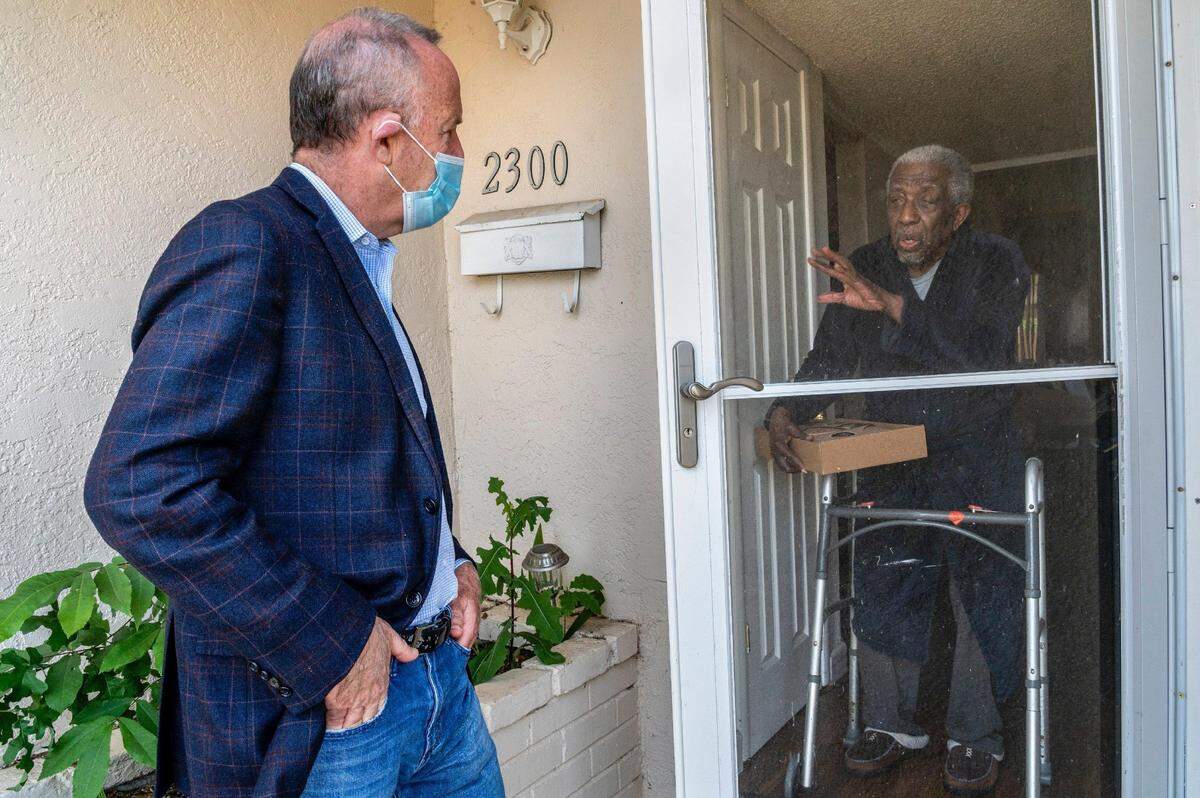 Sacramento Mayor Darrell Steinberg speaks to Warren Tippie, a 97-year old World War II veteran, after delivering a meal as part of the Great Plates Delivered program on May 20, 2020, during the coronavirus pandemic.