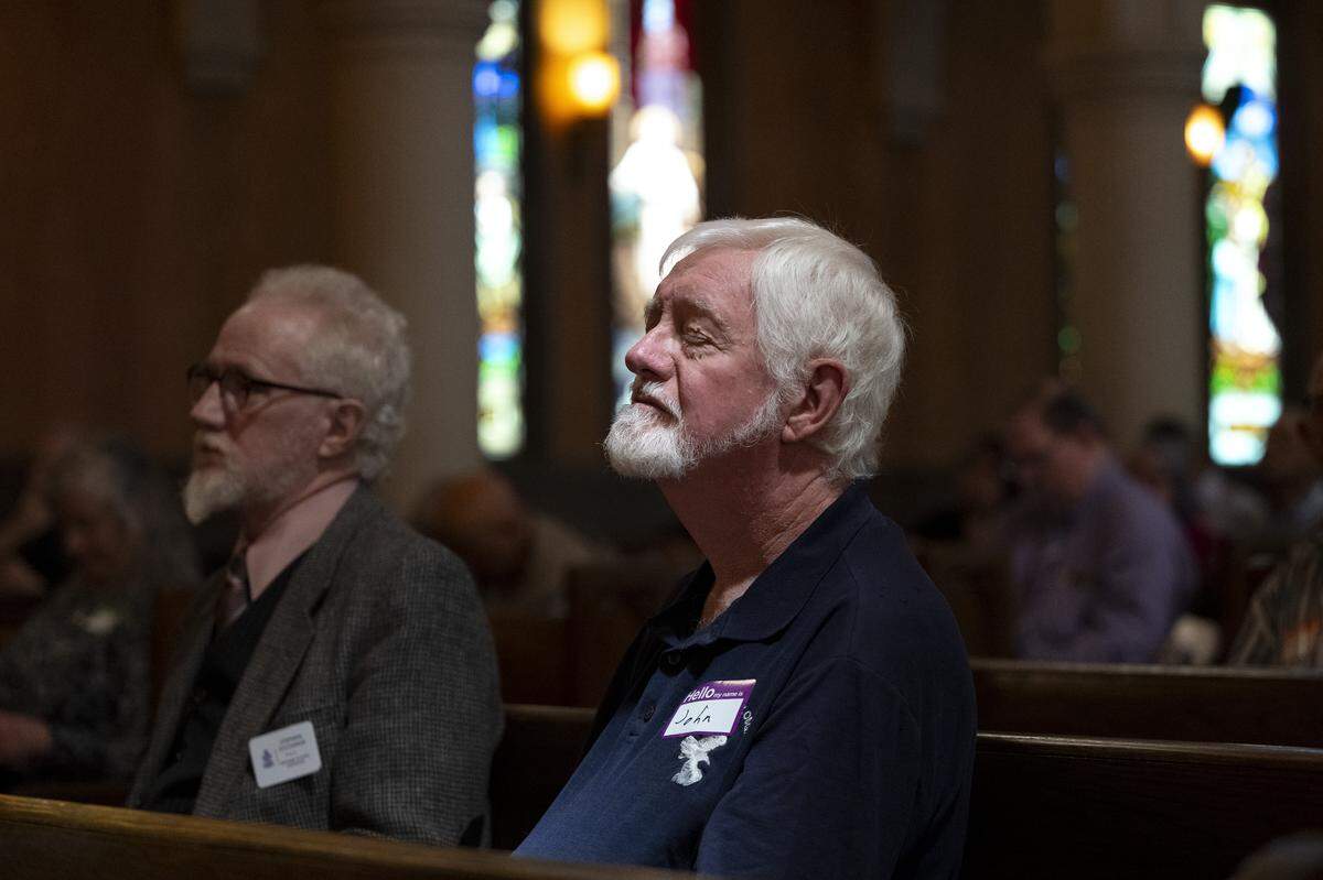 John Couch and Stephen Sylvanus listen to the final service of Pioneer Congregational United Church of Christ at their church on L Street in Sacramento on Sunday, May 31, 2026.