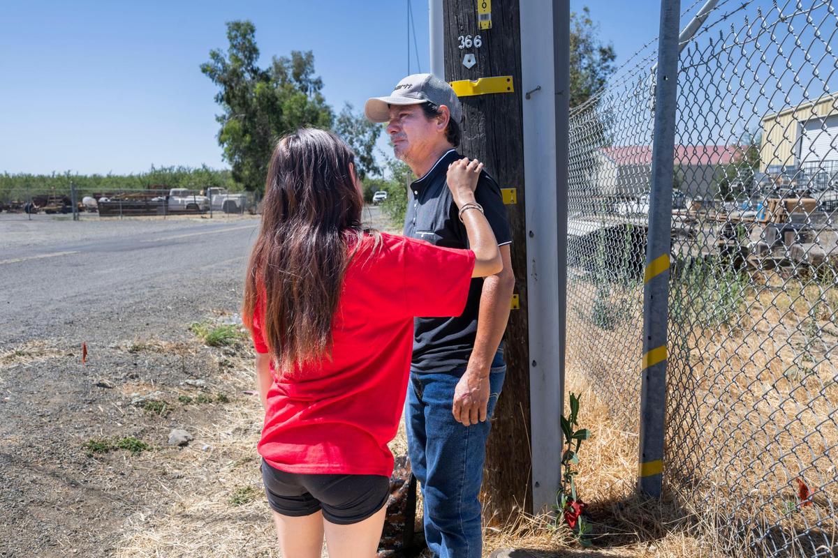 Jhony Ramos, father of fireworks warehouse explosion victims Jhony Ramos Jr. and Jesus Ramos, is comforted after a news conference on Monday. Ramos said he was not allowed to go to the press conference and ask questions about his missing sons.