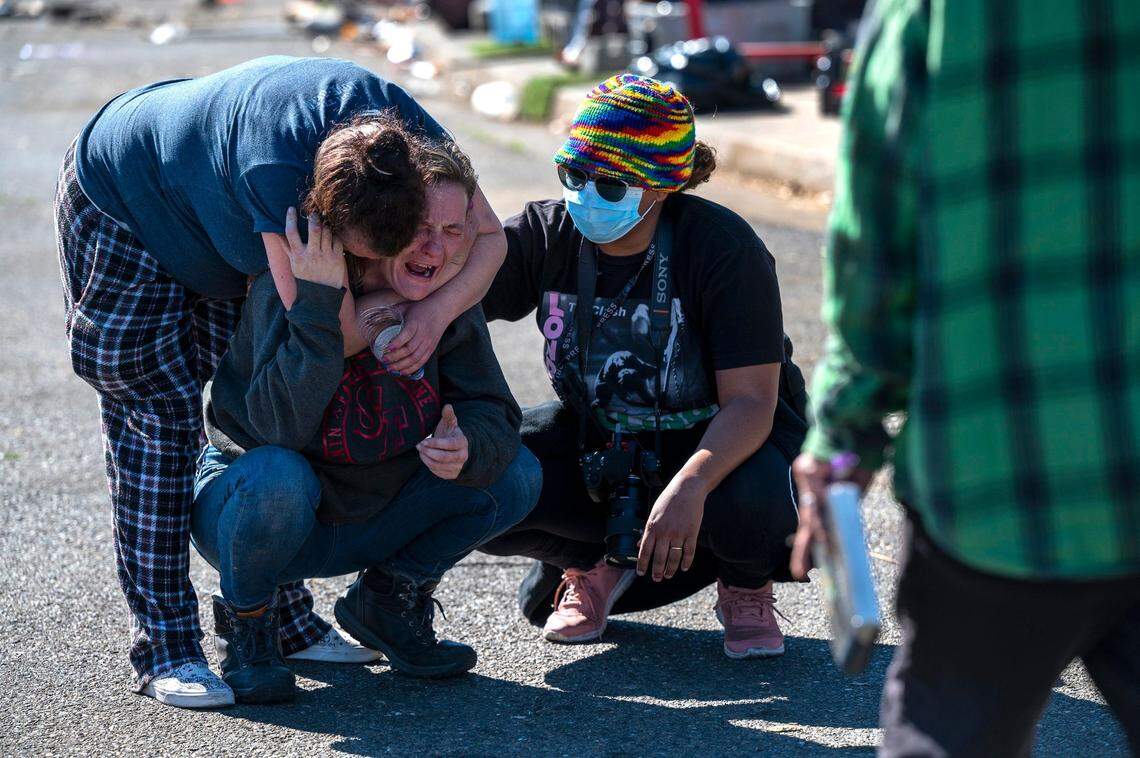 Summer Hamilton, 34, a mother of four children, is comforted after her fathers RV was towed by Sacramento city crews from a homeless encampment on Evergreen Street on Wednesday. She was told she could have a three day extension for her vehicle, because she has children living in it, but she had no idea where she was going to go.