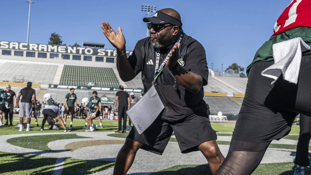 Sacramento State football coach Alonzo Carter gives orders to his players during spring football drills on Thursday, March 19.